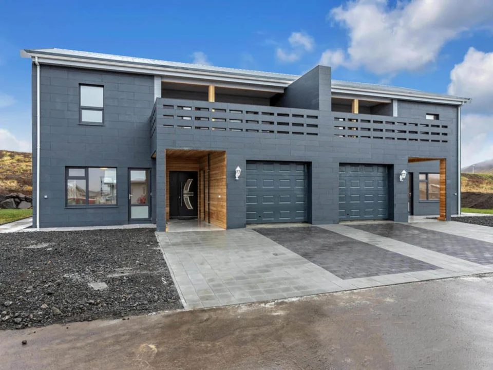 Completed twin villa exterior clad with anthracite self-coloured smooth fibre cement panels