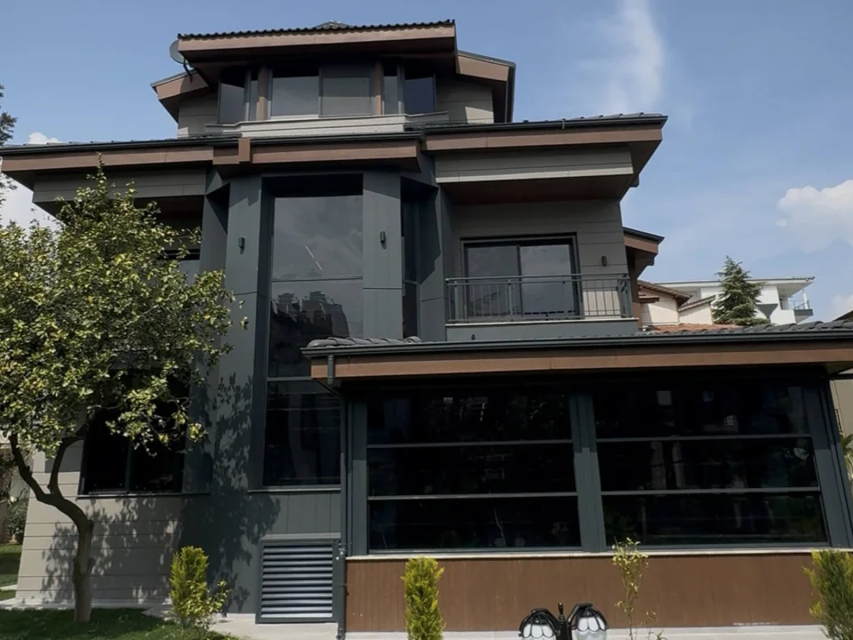 Modern dark charcoal three-storey villa clad in 12 mm horizontally grooved fibre cement facade panels