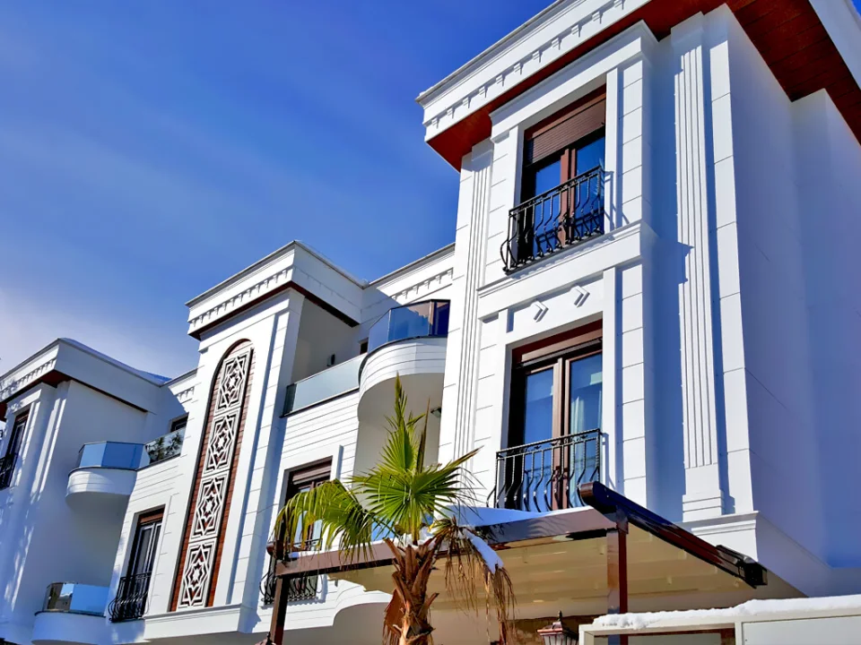 White luxury villa exterior showcasing 20 mm stepped fibre cement window jamb surrounds, pilasters and roofline cornice mouldings